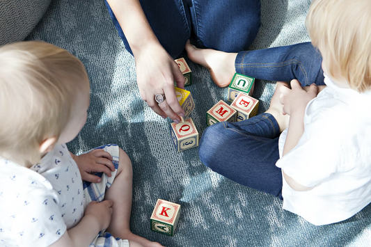 children are playing with blocks with letters