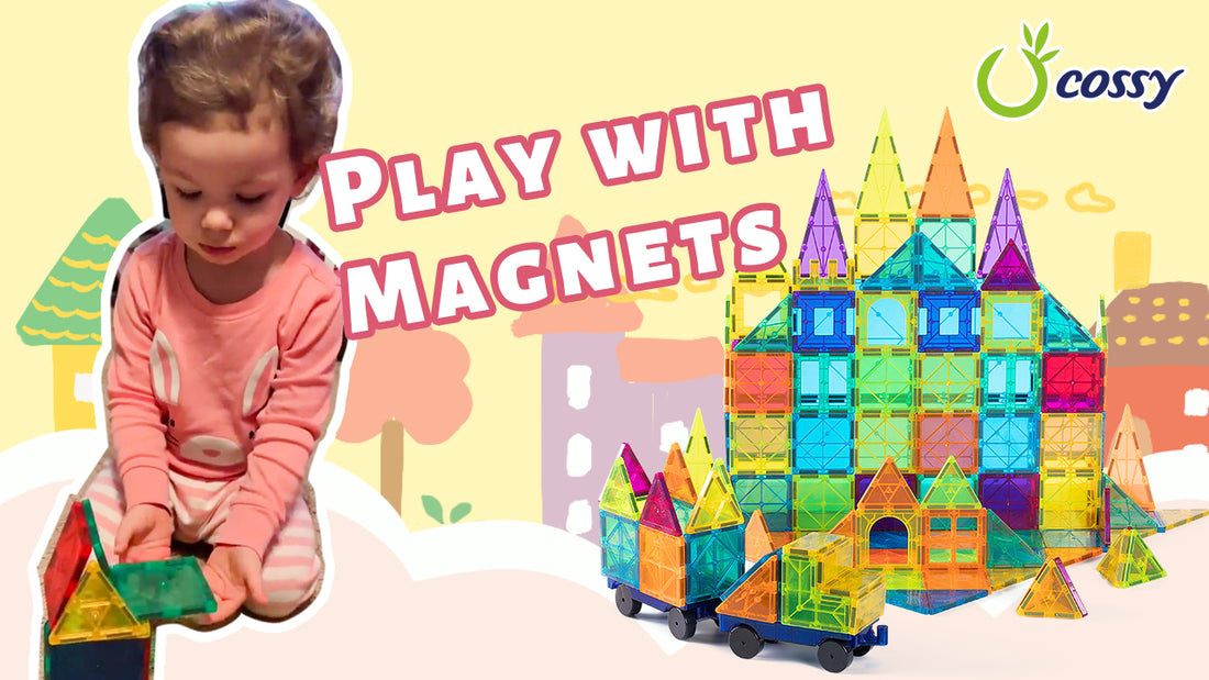 A kid is playing with cossy magnetic tiles