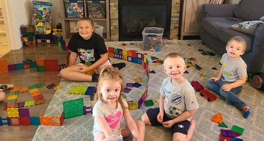 children are playing with magnetic tiles