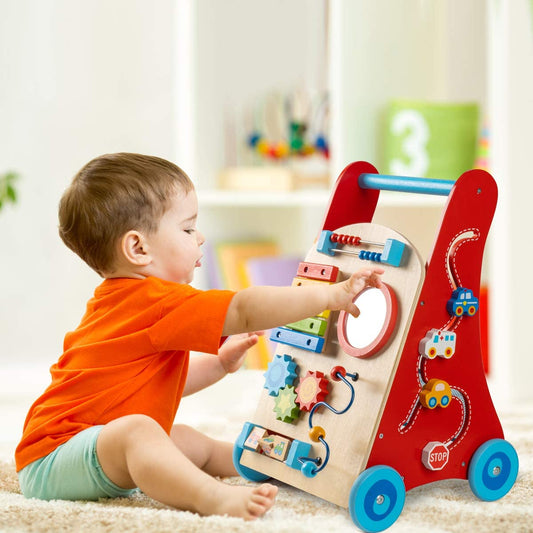 a boy is playing with blocks in front of the wooden walker car